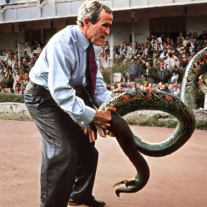 George W Bush lifts a snake
